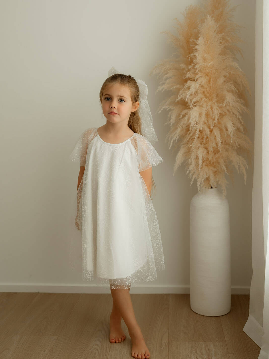 Gia flower girl dress is worn by a young girl.