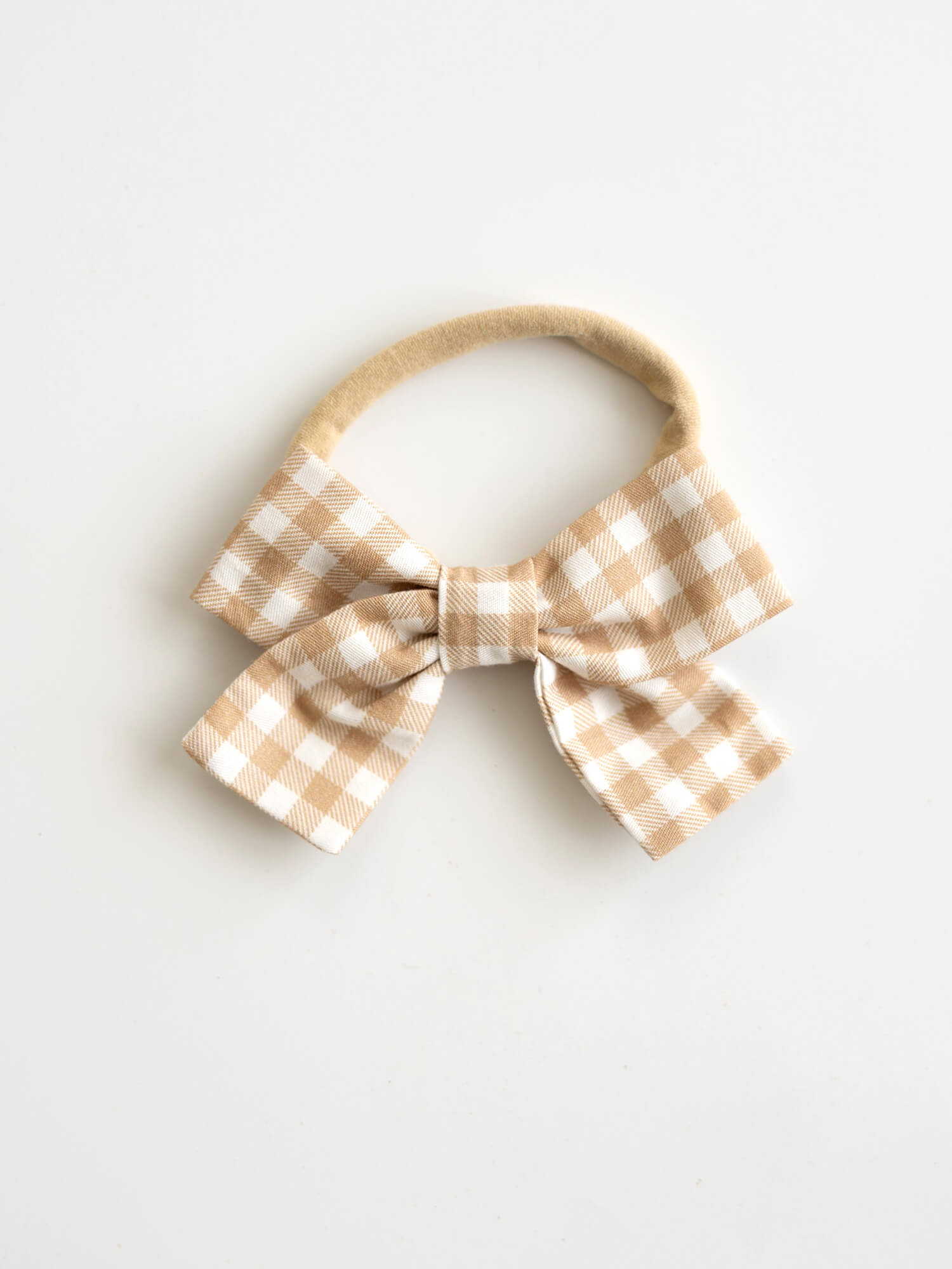 Gingerbread plaid bow on headband, for babies & toddlers.