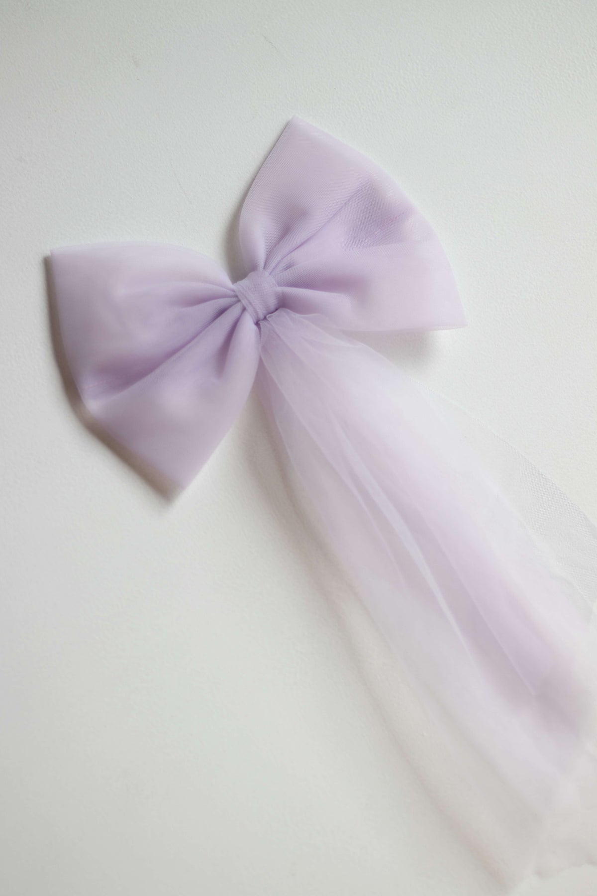 Girls lilac purple tulle hair bow in large size.