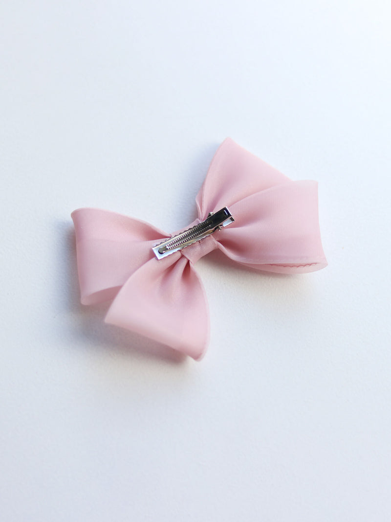 The back of our organza bow hair clip in blush.