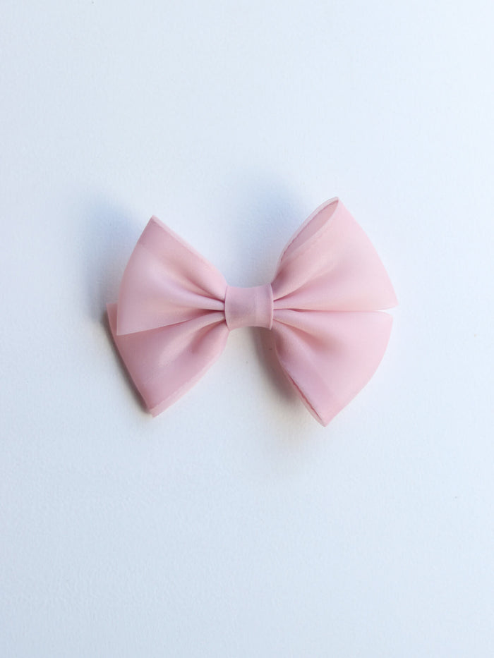 A blush organza bow clip to match our Cleo blush flower girl dress.