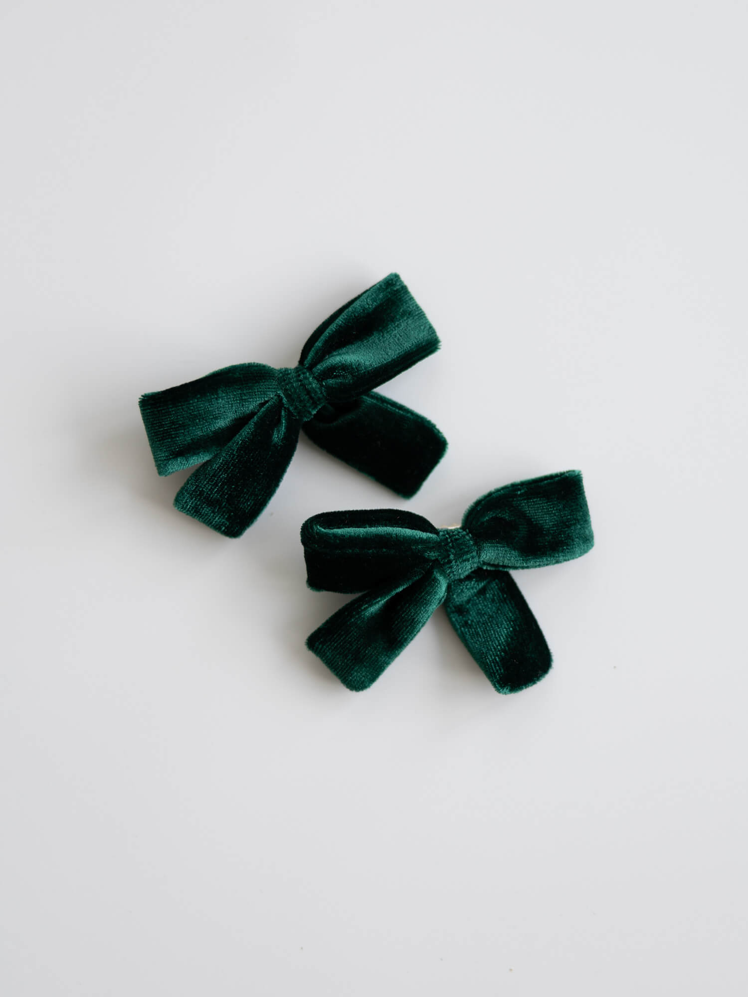 Pair of emerald green velvet hair bows.