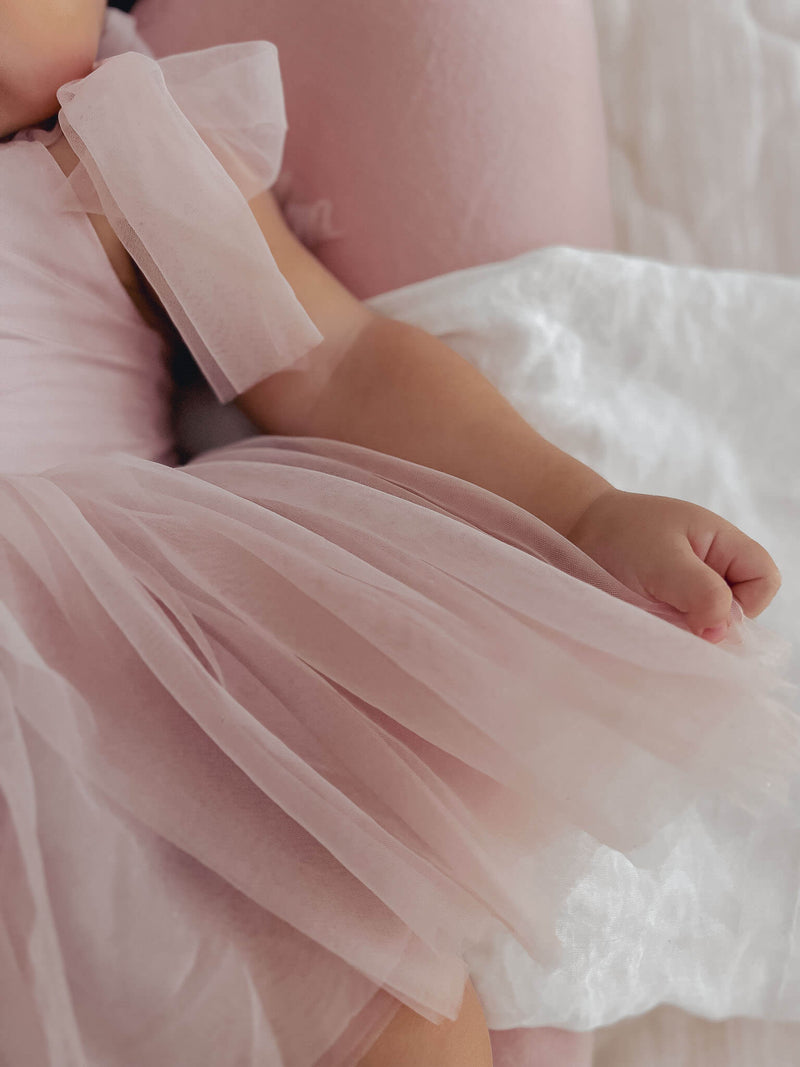 Close view of the soft tulle skirt of our Harper dusty pink baby flower girl romper.