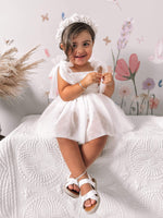 Harper baby flower girl romper in ivory is worn by a toddler.