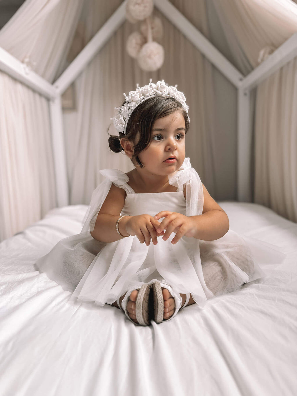 Harper baby flower girl romper in ivory is worn by a toddler.