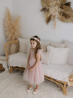 Harper tea length flower girl dress and Elsie girls flower crown are worn by a young girl.