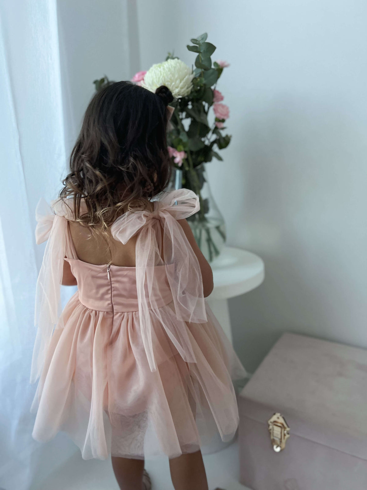 The back of our Isla champagne tulle flower girl romper dress.