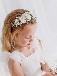 A young flower girl wears our Callie floral headband in ivory.
