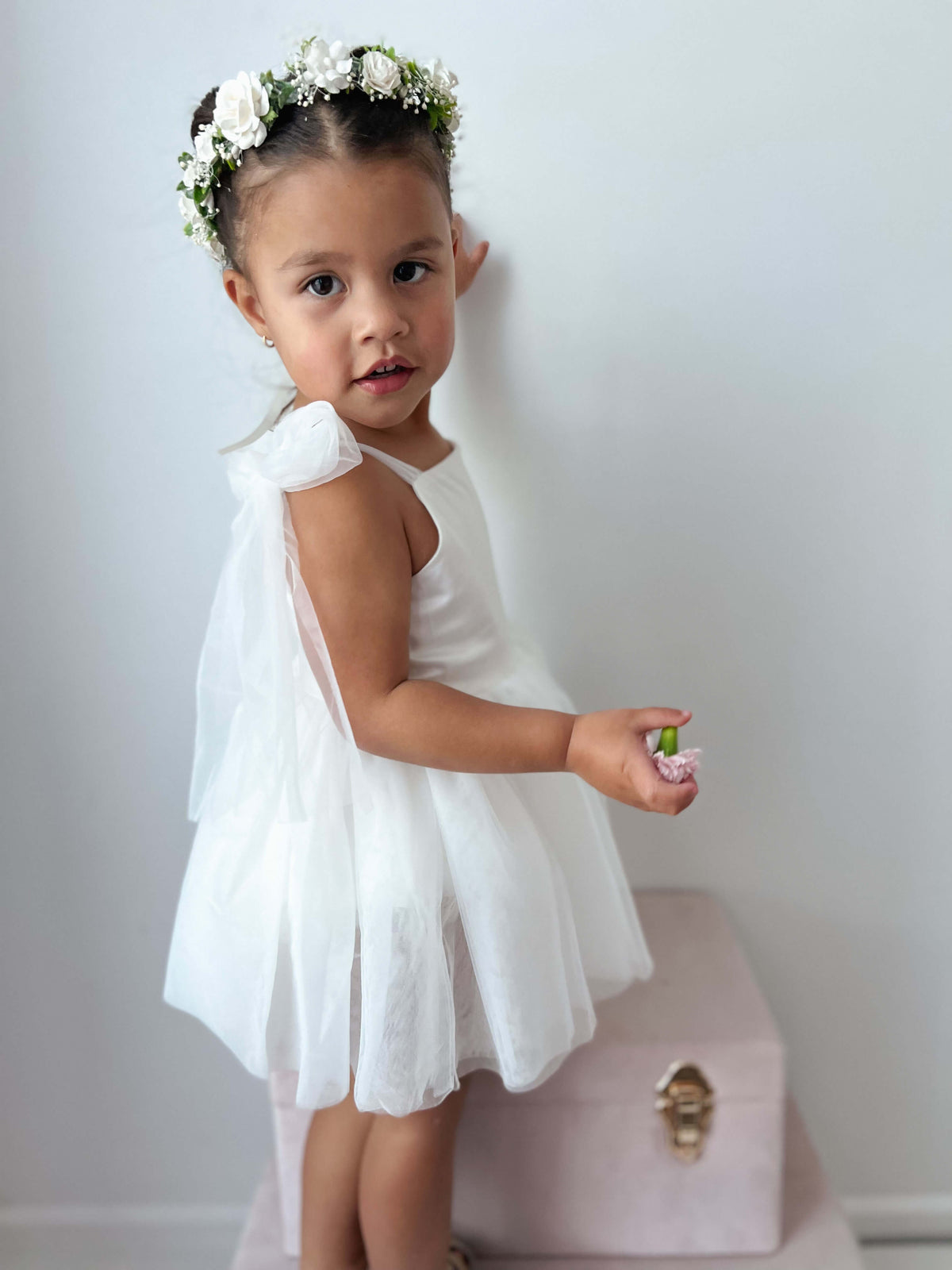 Isla ivory baby flower girl romper is worn by a toddler. She also wears our Elsie ivory flower crown. 