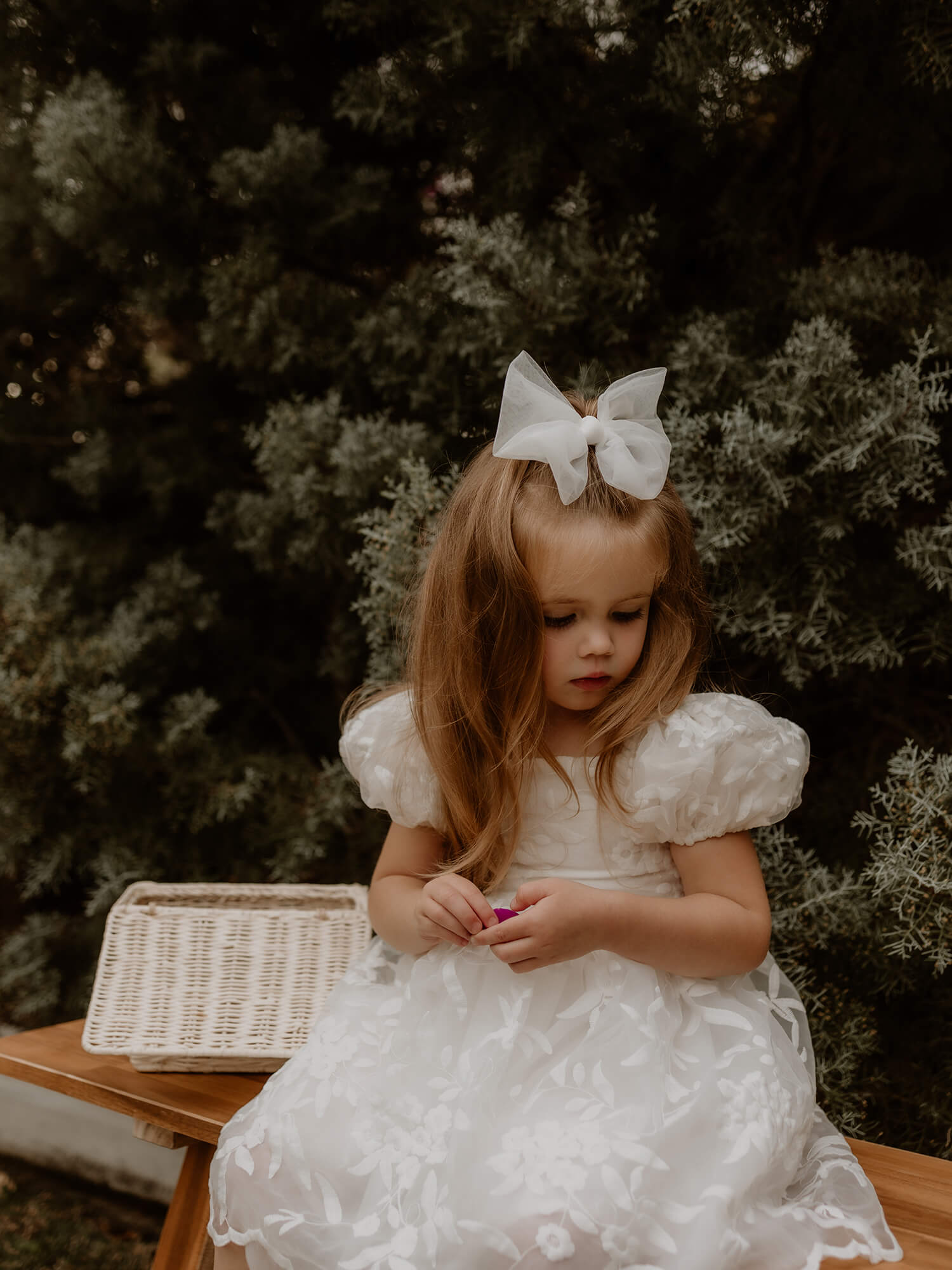 Flower girl wears our Kenzi lace puff sleeve flower girl dress, along with a tulle bow hair clip.