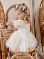 Toddler girl wears our Daisy flower crown and Layla ivory flower girl romper.