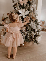 Layla toddler flower girl dress in dusty pink is worn by a toddler.