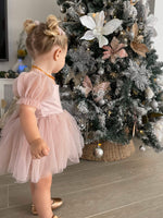 Layla toddler flower girl dress in dusty pink, showing the tulle puff sleeves on the dress, satin bodice and tulle skirt.