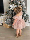 Layla baby flower girl dress in dusty pink shown from the back. Showing the tulle bow tied at the back.