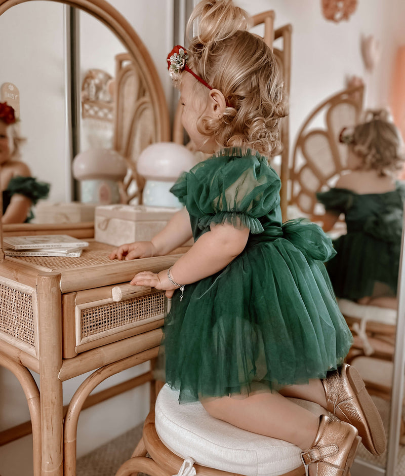 Layla emerald green tulle baby romper is worn by a young toddler.