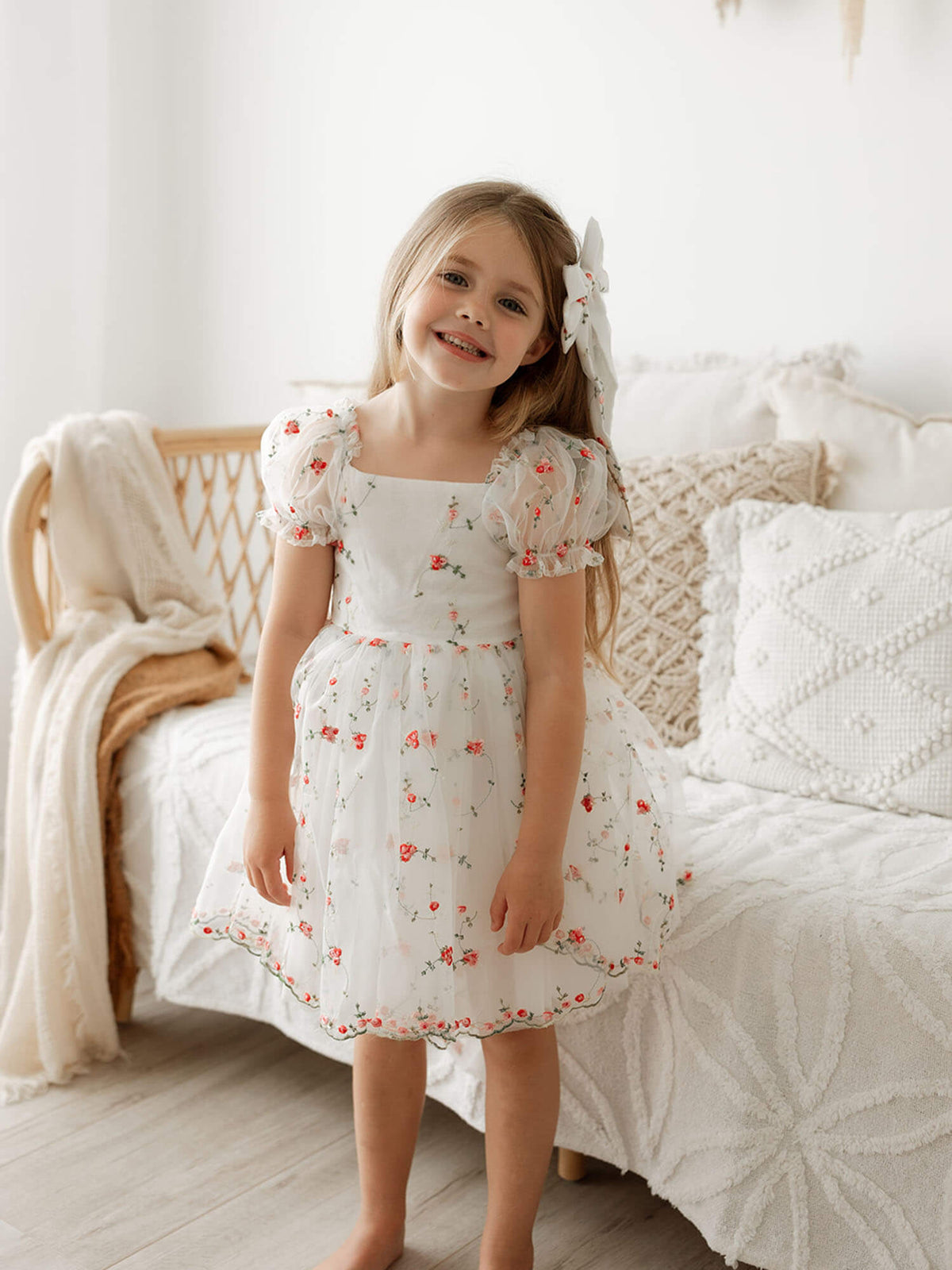 Layla organza dress with red floral embroidery is worn by a young girl.