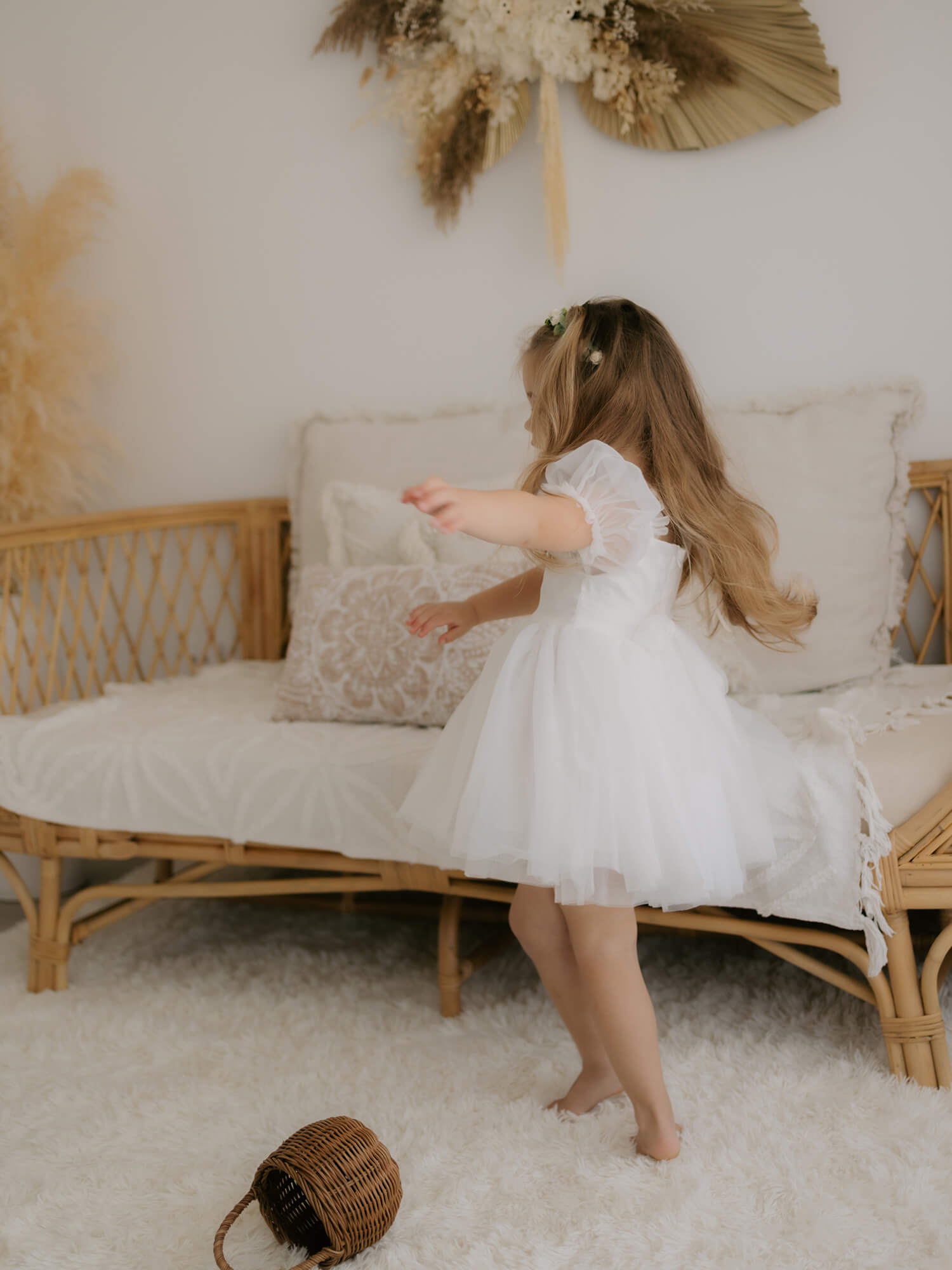 A twirling flower girl wears our Layla tulle puff sleeve flower girl dress.