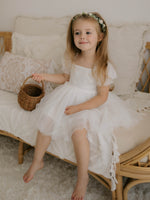 Layla flower girl dress in ivory is worn by a young girl, she is also wearing our Eden flower crown.