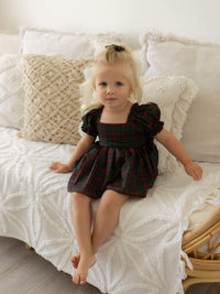 Mila Christmas baby romper is worn by a toddler.