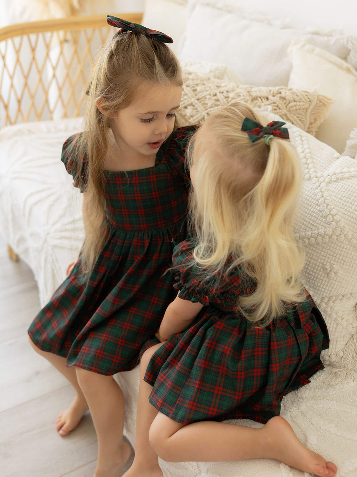 Mila Christmas plaid girls dress & matching romper are worn by two sisters.