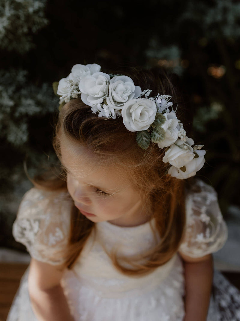 Rose flower crown and Pippa flower girl dress are worn by a young girl.