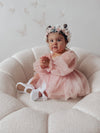 Toddler wears our Wren baby flower girl dress showing the full length tulle sleeves.