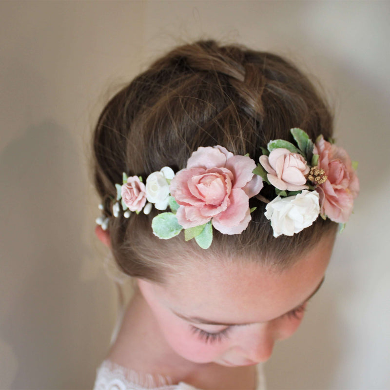 Child wears our Amelie flower crown which is dusty pink and ivory with gold accents. 