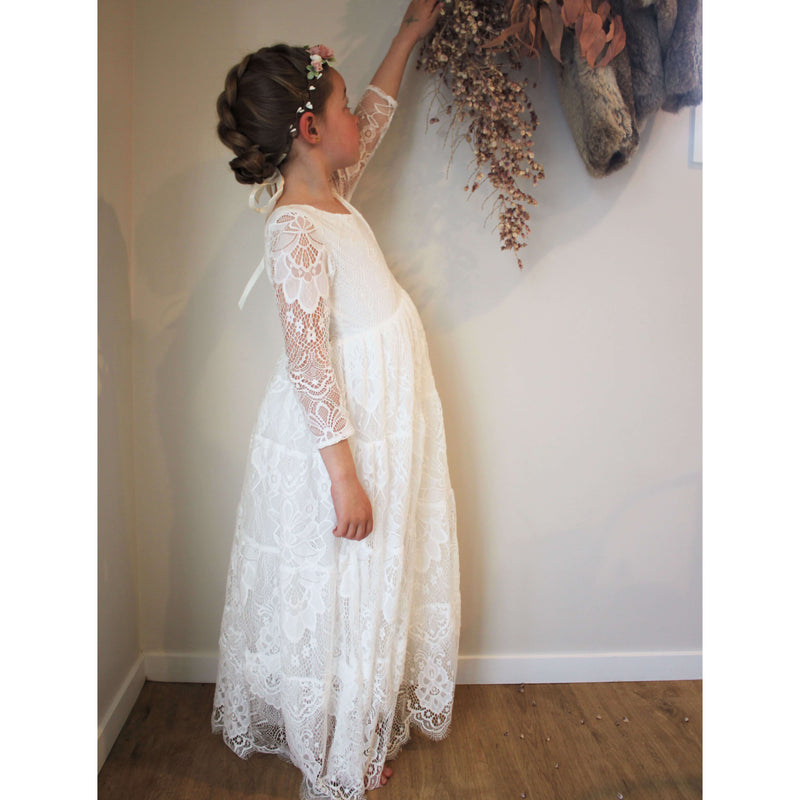 Lumi lace flower girl dress worn by a girl, showing the lace details of the full length sleeve.