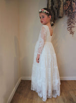 Lumi ivory lace flower girl dress being worn by a young girl, along with our Amelie dusty pink flower crown.