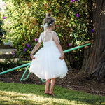 Margot ivory flower girl dress shown from behind, showing the shirring at the back of the bodice.