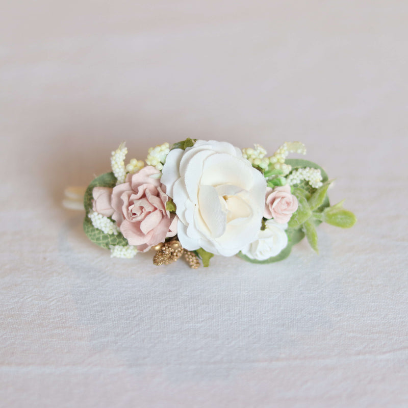 Norah baby girl flower crown floral headband shown from the front, showing ivory and blush flowers and sage coloured greenery, with gold accents.