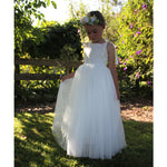 Sonnet flower girl dress in ivory and Grace flower crown worn by a young girl.