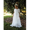 Full length lace girls dress, our Violette flower girl dress, being worn by a young girl. Along with an ivory flower crown, our Delilah floral headband.