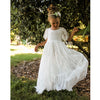 Violette lace flower girl dress showing the lace detail, worn by a flower girl with a matching floral headband.
