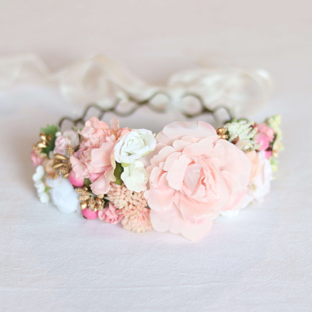 Aria girls flower crown in peachy blush. A flower crown of peach, blush, ivory and pink blooms with gold accents. A tie back flower crown with a ribbon.