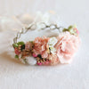 Aria girls flower crown in peachy blush. A flower crown of peach, blush, ivory and pink blooms with gold accents. A tie back flower crown with a ribbon.