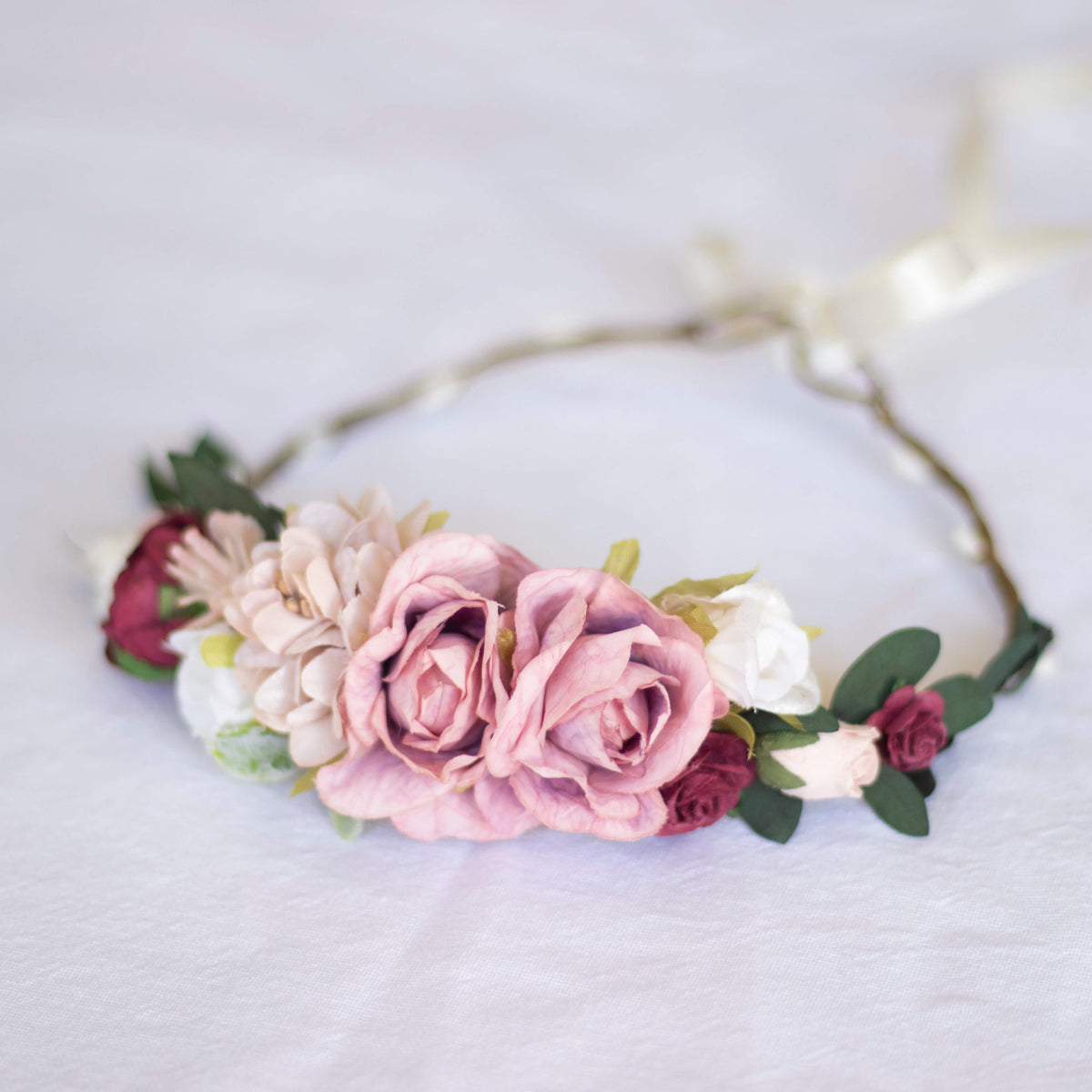 Side view of our Audrey girls flower crown, showing two main pink roses, with accents of taupe, ivory and wine colours.