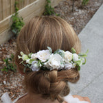 Flower girl wears our Ava floral comb, shown from above her up-do, showing details of the wedding hair do and hair comb.