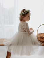 Belle flower girl dress with lace back is worn by a young girl.