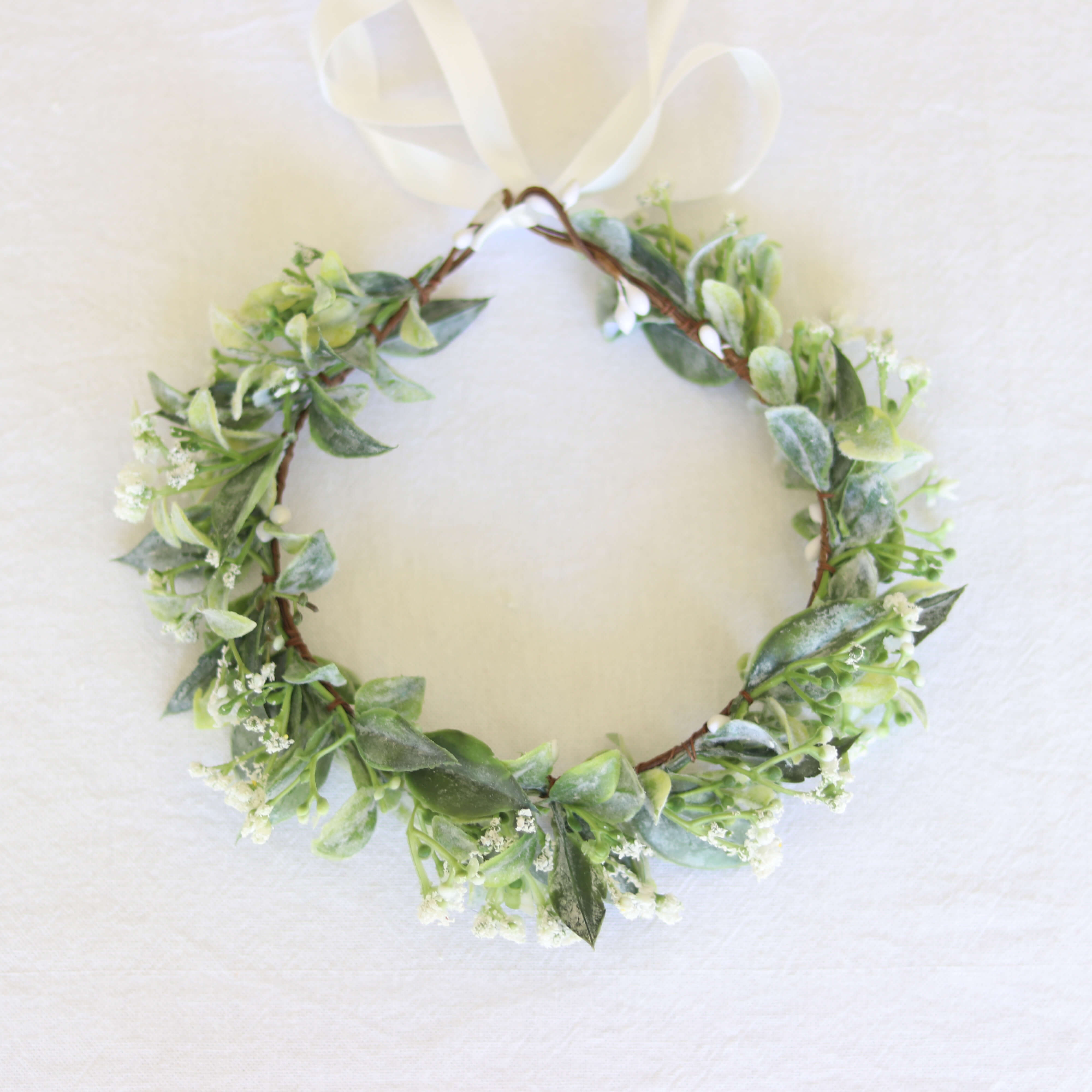 Blythe girls flower crown shown from above. Showing greenery and baby's breath.