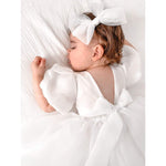 Cleo puff sleeve flower girl dress is worn by a sleeping baby flower girl.