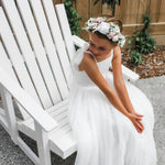 Daisy flower crown and Harper tulle flower girl dress being worn by a child.