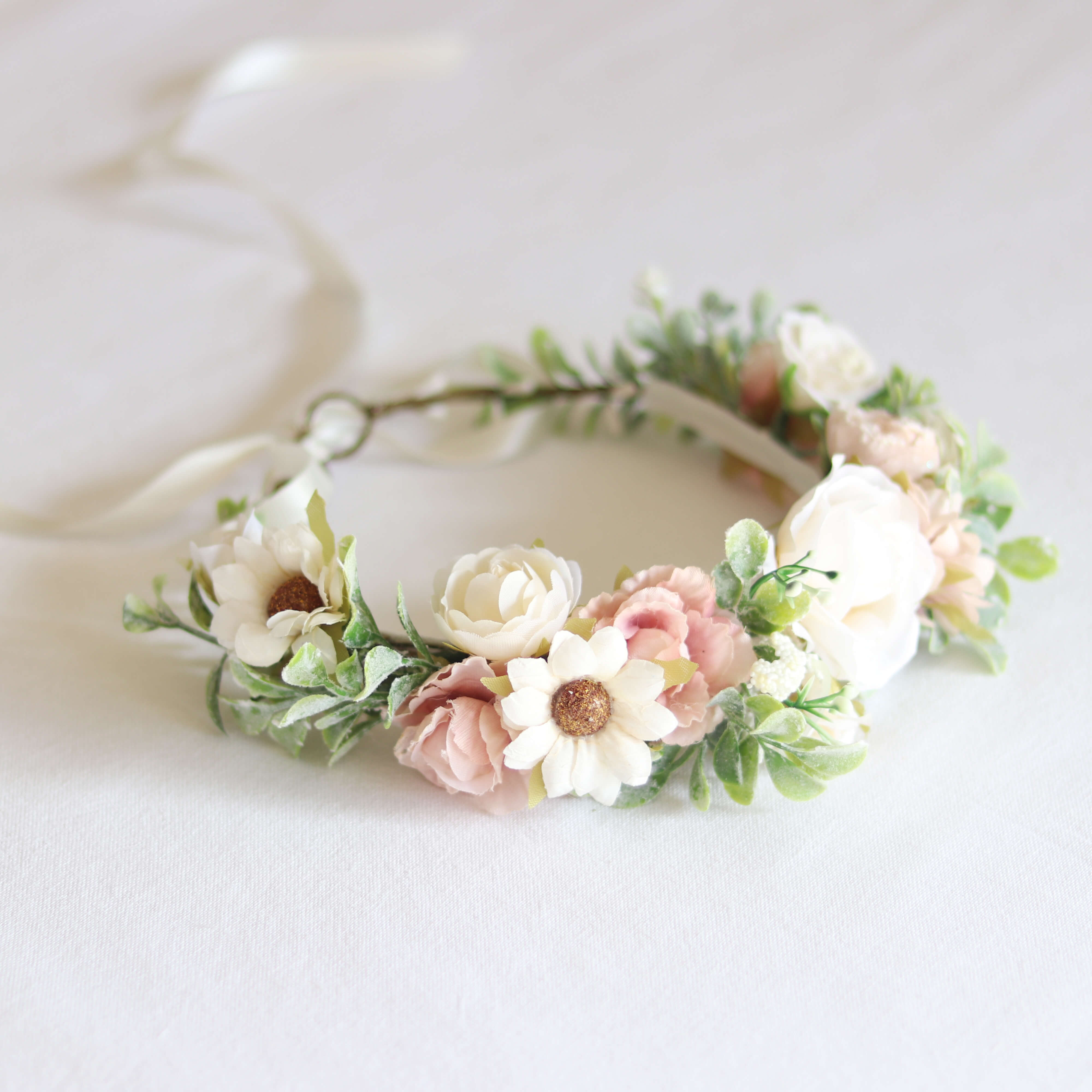 Daisy girls flower crown shown from the side focusing on an ivory daisy on the flower crown.