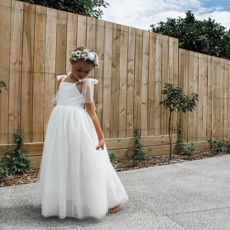 Daisy flower crown and Harper flower girl dress being worn by a young girl.