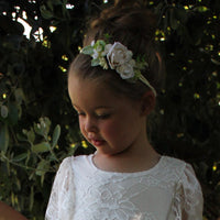 Child wears our Delilah ivory floral headband and lace flower girl dress.