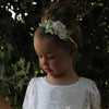 Child wears our Delilah ivory floral headband and lace flower girl dress.