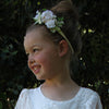 Girl wears our ivory Delilah floral headband and our Violette lace flower girl dress.