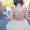 Everly floral tulle romper from the back, showing the tie back, being worn by a toddler.