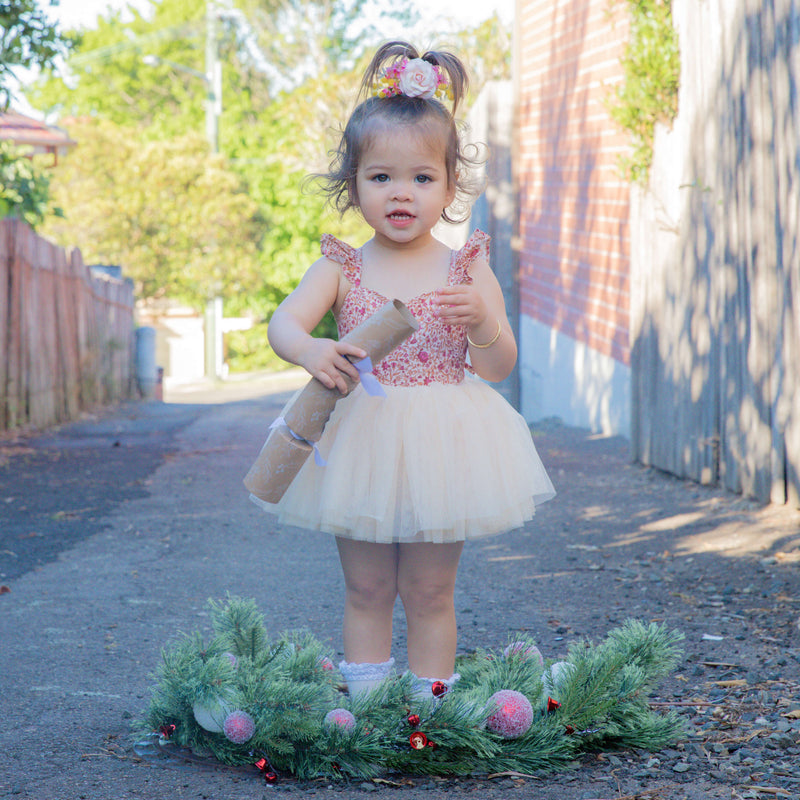 Everly baby Christmas romper being worn by a toddler.