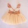 Back of our Everly tulle baby romper, showing the tie back detail, ruffle sleeves and cream tulle skirt.